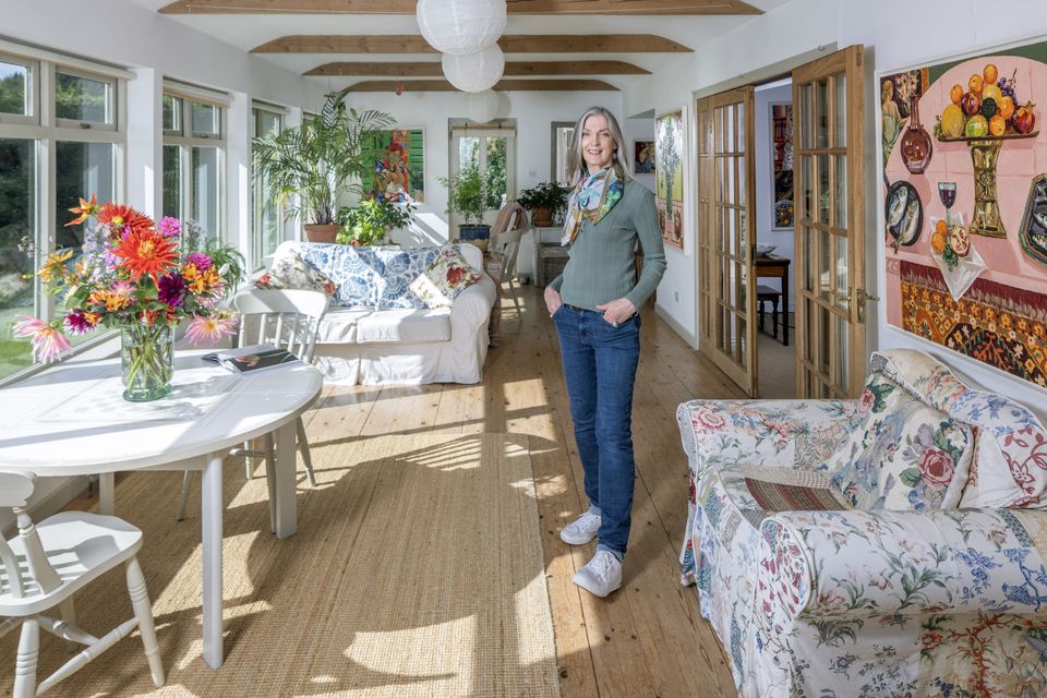 Artist Lucy Doyle in the sunroom of her bungalow in Co Wicklow. The sunroom, which runs the length of the house, was added eight years after she and her husband Nick Gray built the house in 1991. Photo: Tony Gavin